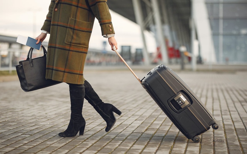 Thailand Visa on Arrival – Woman Walking with Trolley Bag at Airport