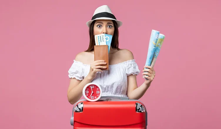 Young woman holding travel tickets and a map