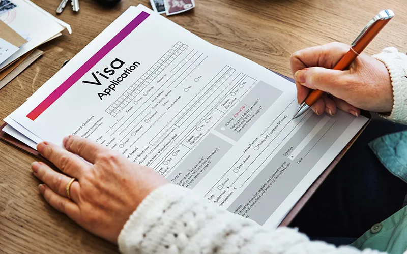 Visa application form with travel documents concept