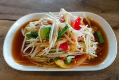 Thai green papaya salad Som Tum with peanuts, lime, and chili